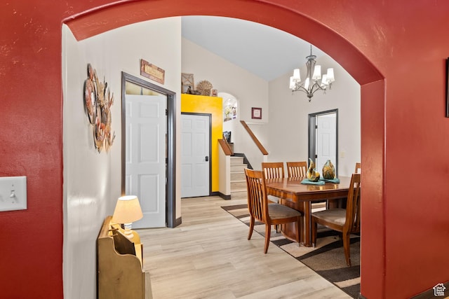98 E Mt Peale Dr, Moab, UT 84532 - dining area with arched walkways, lofted ceiling, a chandelier, and light wood-type flooring