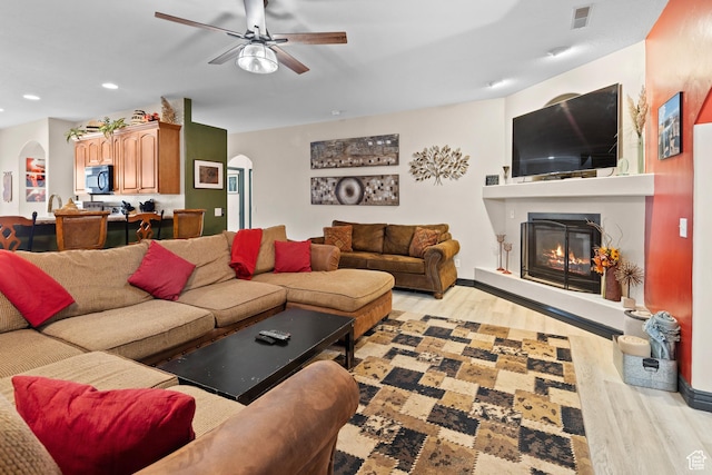 98 E Mt Peale Dr, Moab, UT 84532 - living room with a glass covered fireplace, light wood-style flooring, arched walkways, ceiling fan, and recessed lighting