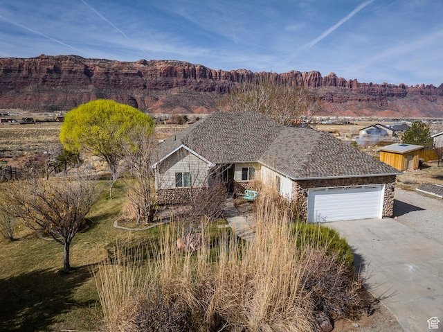 98 E Mt Peale Dr, Moab, UT 84532 - view of front of house featuring driveway, a garage, and a mountain view