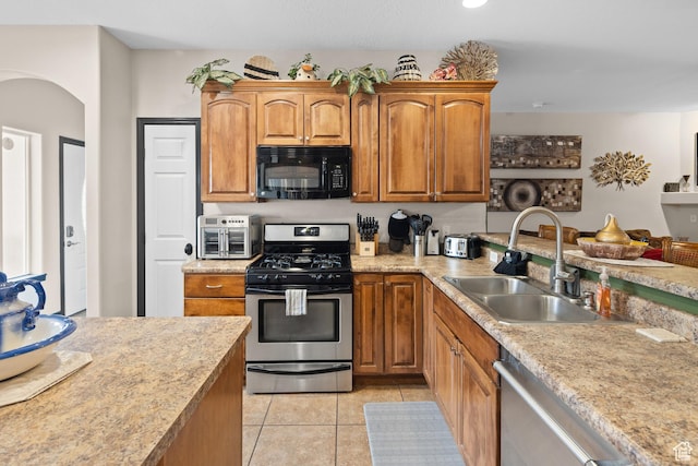 98 E Mt Peale Dr, Moab, UT 84532 - kitchen featuring light countertops, a sink, arched walkways, and appliances with stainless steel finishes