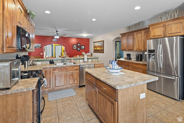 98 E Mt Peale Dr, Moab, UT 84532 - kitchen with a sink, a ceiling fan, appliances with stainless steel finishes, light tile patterned floors, and arched walkways