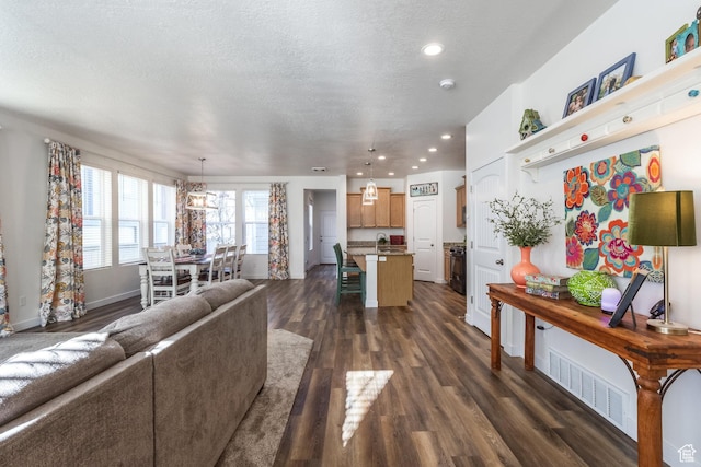 6321 W Moon Valley Dr, South Jordan, UT 84009 - living room featuring baseboards, recessed lighting, a textured ceiling, dark wood-type flooring, and visible vents