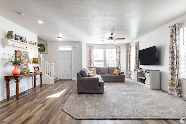 6321 W Moon Valley Dr, South Jordan, UT 84009 - living room with ceiling fan, a textured ceiling, visible vents, stairway, and wood finished floors