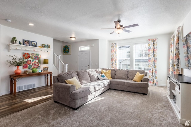 6321 W Moon Valley Dr, South Jordan, UT 84009 - living room with visible vents, ceiling fan, carpet, a textured ceiling, and stairs