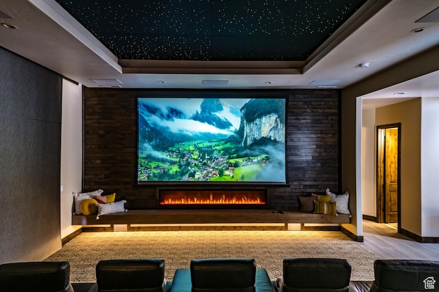 5024 W Nashoba Trl Unit 74, Hurricane, UT 84737 - cinema with a tray ceiling, wood finished floors, and a warm lit fireplace