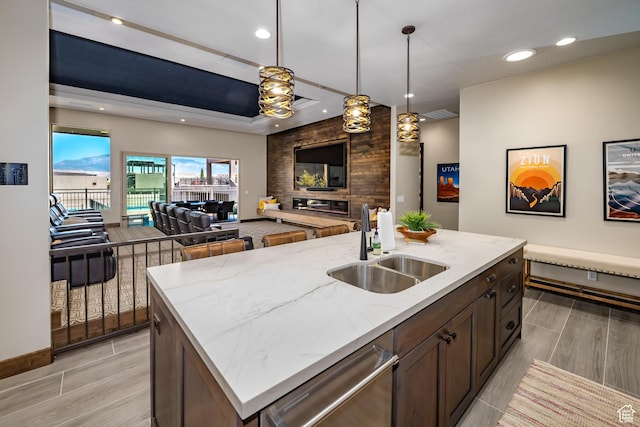 5024 W Nashoba Trl Unit 74, Hurricane, UT 84737 - kitchen featuring hanging light fixtures, a sink, open floor plan, light stone countertops, and dishwasher