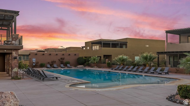 5024 W Nashoba Trl Unit 74, Hurricane, UT 84737 - pool at dusk featuring a patio area and a community pool