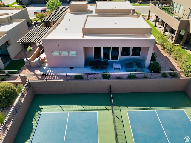 5024 W Nashoba Trl Unit 74, Hurricane, UT 84737 - back of property with fence, a patio, stucco siding, and an outdoor living space