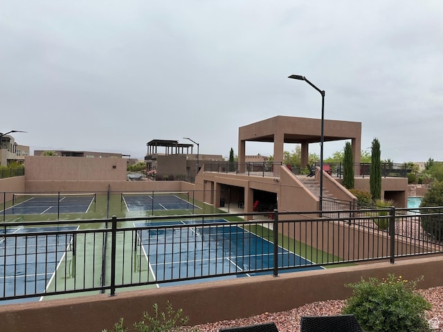 5024 W Nashoba Trl Unit 74, Hurricane, UT 84737 - view of swimming pool featuring a tennis court and fence