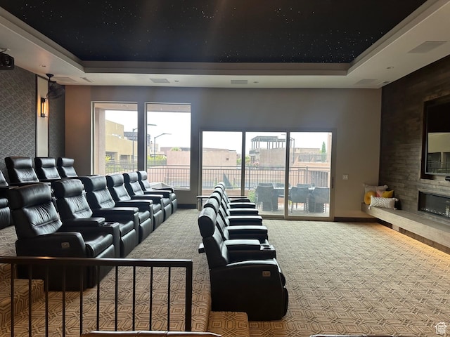 5024 W Nashoba Trl Unit 74, Hurricane, UT 84737 - carpeted home theater with a large fireplace, plenty of natural light, baseboards, and a tray ceiling