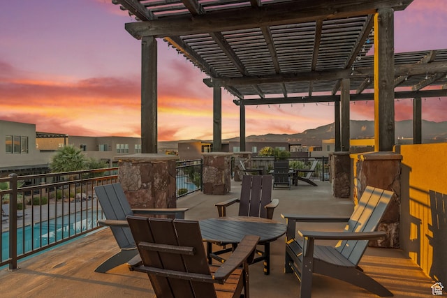 5024 W Nashoba Trl Unit 74, Hurricane, UT 84737 - patio terrace at dusk featuring a community pool and a pergola