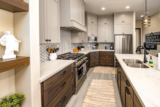 5024 W Nashoba Trl Unit 74, Hurricane, UT 84737 - kitchen featuring high end appliances, light stone counters, tasteful backsplash, and a sink