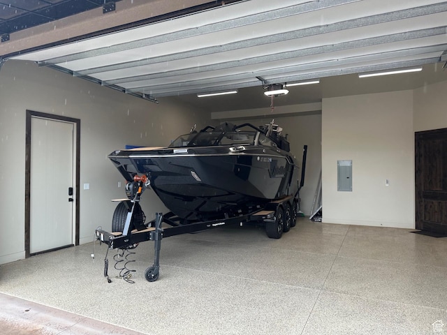 5024 W Nashoba Trl Unit 74, Hurricane, UT 84737 - garage with baseboards, electric panel, and a garage door opener