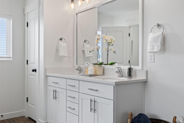 988 E Harrier St N, Eagle Mountain, UT 84005 - full bath with double vanity, a sink, baseboards, and wood finished floors