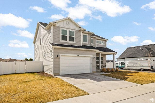 988 E Harrier St N, Eagle Mountain, UT 84005 - view of front of house featuring a gate, fence, a garage, concrete driveway, and a front lawn