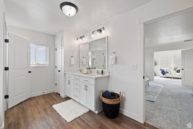 988 E Harrier St N, Eagle Mountain, UT 84005 - bathroom with baseboards, wood finished floors, a sink, and a textured ceiling