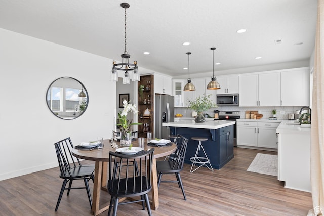 988 E Harrier St N, Eagle Mountain, UT 84005 - dining space featuring a chandelier, wood finished floors, baseboards, visible vents, and recessed lighting