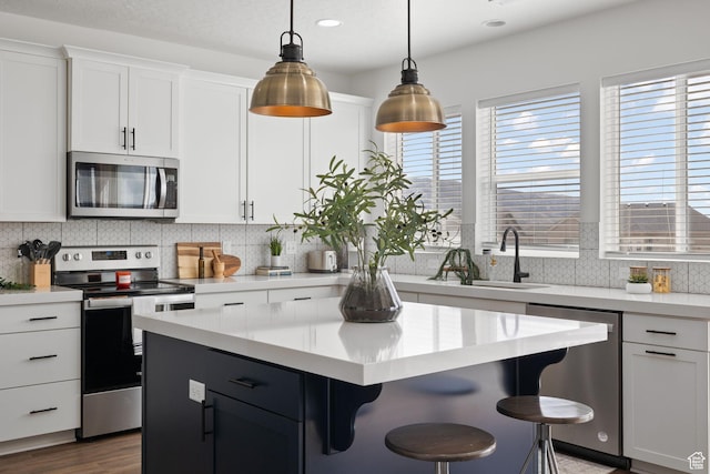 988 E Harrier St N, Eagle Mountain, UT 84005 - kitchen featuring light countertops, a sink, stainless steel appliances, and tasteful backsplash