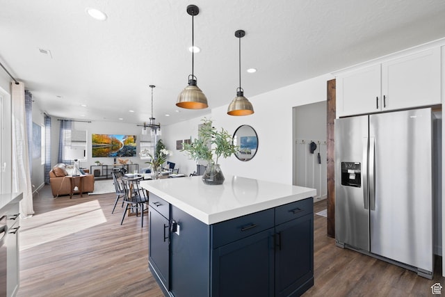 988 E Harrier St N, Eagle Mountain, UT 84005 - kitchen featuring open floor plan, decorative light fixtures, stainless steel fridge with ice dispenser, dark wood-type flooring, and white cabinets
