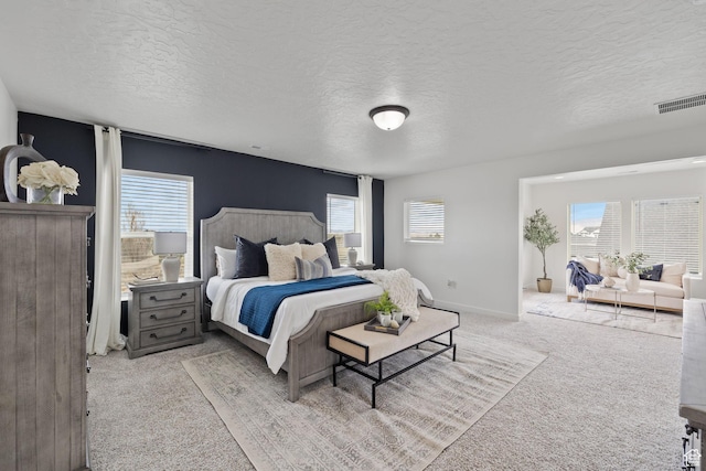 988 E Harrier St N, Eagle Mountain, UT 84005 - carpeted bedroom with multiple windows, visible vents, baseboards, and a textured ceiling