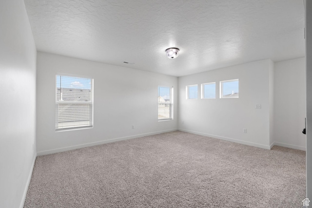 988 E Harrier St N, Eagle Mountain, UT 84005 - spare room featuring carpet flooring, baseboards, and a textured ceiling