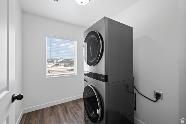988 E Harrier St N, Eagle Mountain, UT 84005 - laundry room with stacked washer / dryer, dark wood-style flooring, baseboards, and laundry area