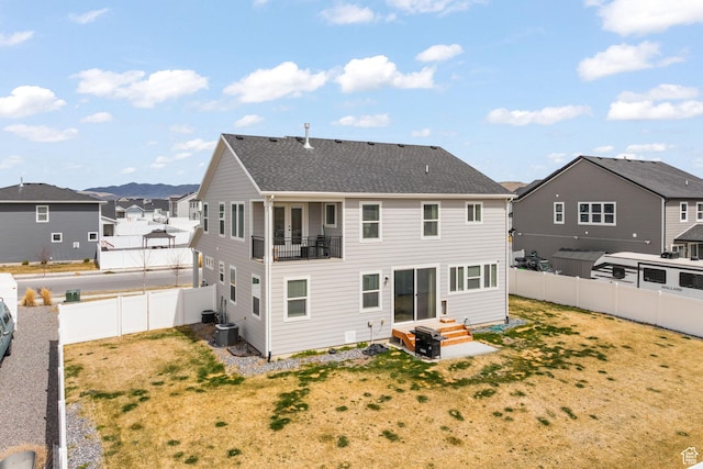 988 E Harrier St N, Eagle Mountain, UT 84005 - back of property featuring central air condition unit, roof with shingles, a fenced backyard, a residential view, and a yard
