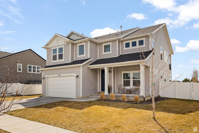 988 E Harrier St N, Eagle Mountain, UT 84005 - view of front of home with covered porch, concrete driveway, fence, an attached garage, and a front lawn