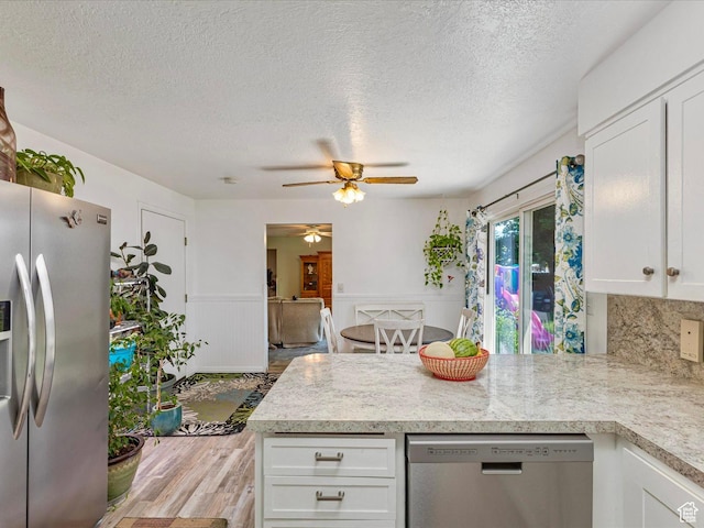 850 W 370 S, Logan, UT 84321 - kitchen with stainless steel appliances, wood finished floors, ceiling fan, a peninsula, and light countertops