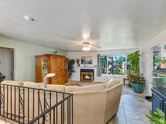 850 W 370 S, Logan, UT 84321 - living room with a glass covered fireplace, a ceiling fan, a textured ceiling, and light tile patterned flooring