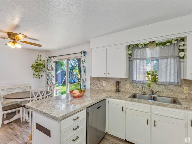 850 W 370 S, Logan, UT 84321 - kitchen with stainless steel dishwasher, a sink, light countertops, a peninsula, and a textured ceiling