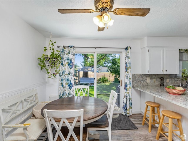 850 W 370 S, Logan, UT 84321 - dining area featuring light wood-type flooring, a textured ceiling, and a ceiling fan