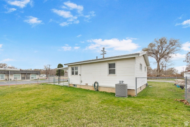 510 S Grant E, Ogden, UT 84404 - back of property featuring central AC unit, fence, and a lawn