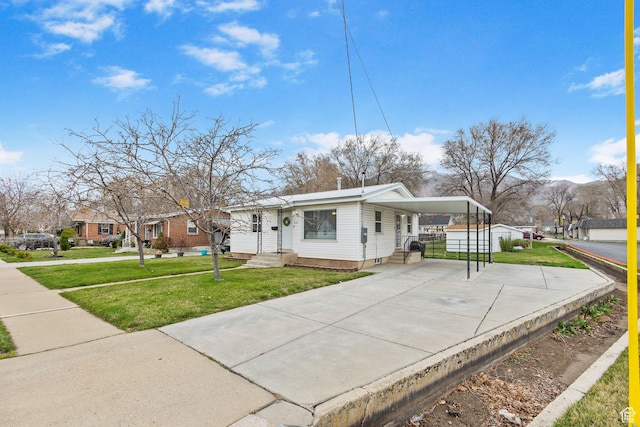 510 S Grant E, Ogden, UT 84404 - view of front facade with a front yard, concrete driveway, fence, a carport, and entry steps