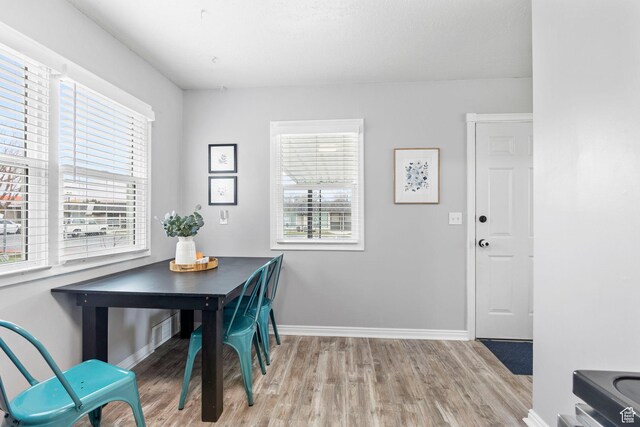 510 S Grant E, Ogden, UT 84404 - dining room with baseboards, visible vents, a wealth of natural light, and light wood-style flooring