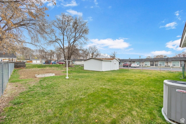 510 S Grant E, Ogden, UT 84404 - view of yard with central air condition unit, an outbuilding, and fence