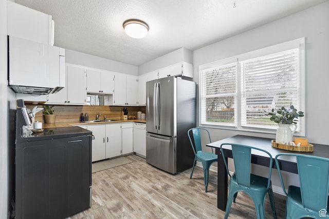 510 S Grant E, Ogden, UT 84404 - kitchen with a sink, freestanding refrigerator, black electric range oven, light wood-style flooring, and white cabinets