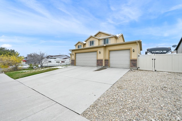 6007 W Jargon Way, Salt Lake City, UT 84118 - view of front of home with concrete driveway, stucco siding, fence, an attached garage, and a gate