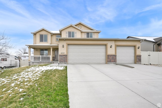 6007 W Jargon Way, Salt Lake City, UT 84118 - view of front of home featuring stucco siding, a gate, fence, and concrete driveway
