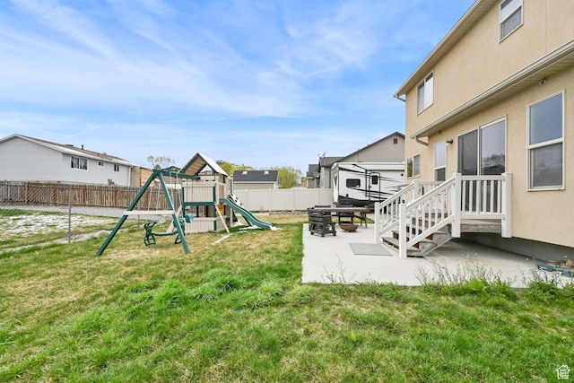 6007 W Jargon Way, Salt Lake City, UT 84118 - view of yard with a fenced backyard, a patio area, and a playground