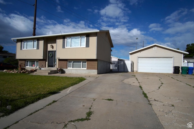 7598 S 2290 W, West Jordan, UT 84084 - view of front facade with a front lawn, a gate, brick siding, a garage, and an outbuilding