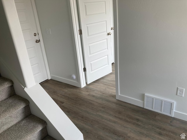 stairs featuring baseboards, visible vents, and wood finished floors