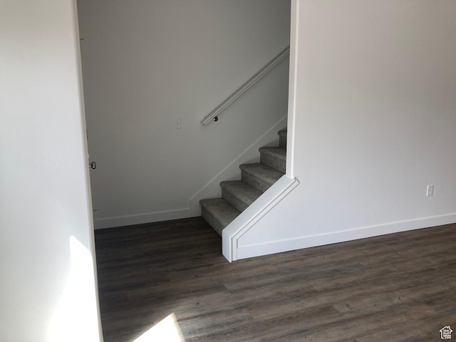 stairs featuring baseboards and wood finished floors
