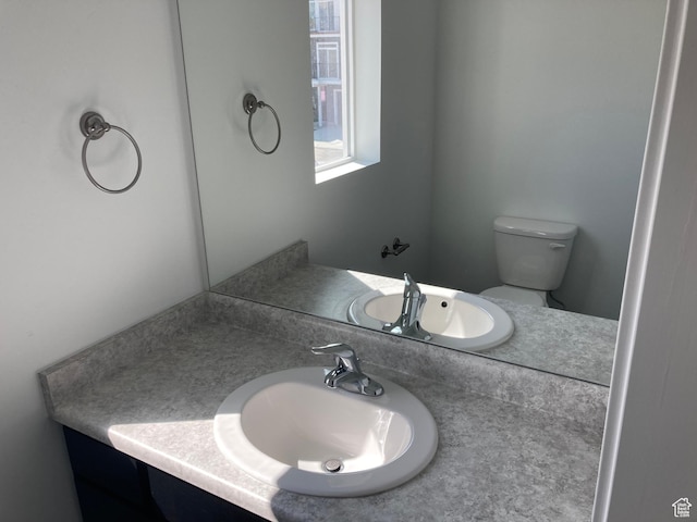 half bathroom with toilet and vanity