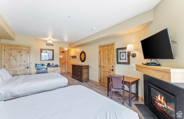 2669 Canyons Resort Dr Unit 312, Park City, UT 84098 - bedroom with baseboards, visible vents, and a glass covered fireplace