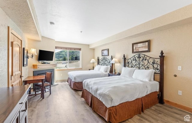 2669 Canyons Resort Dr Unit 312, Park City, UT 84098 - bedroom featuring a textured wall, baseboards, and light wood finished floors