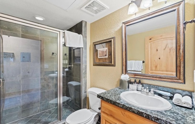 2669 Canyons Resort Dr Unit 312, Park City, UT 84098 - bathroom with a stall shower, toilet, vanity, visible vents, and a textured wall