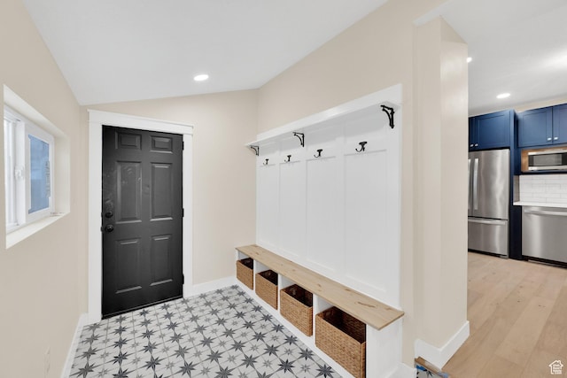 mudroom with baseboards, lofted ceiling, and recessed lighting