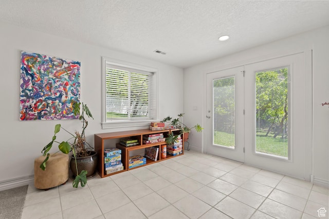dining area with a textured ceiling, light tile patterned floors, recessed lighting, and baseboards