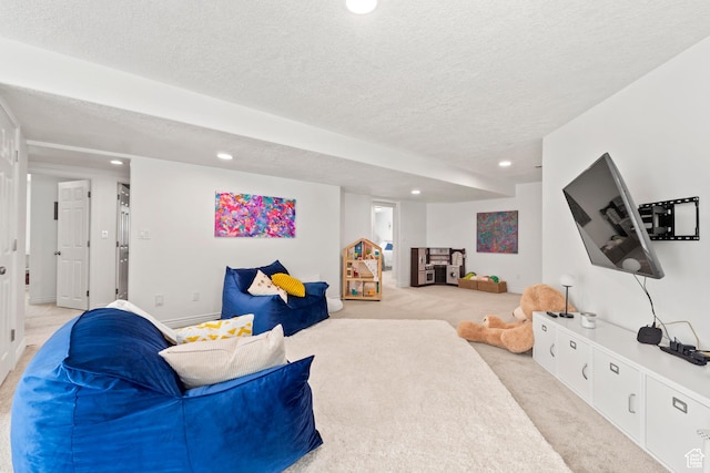 living area with recessed lighting, light colored carpet, and a textured ceiling